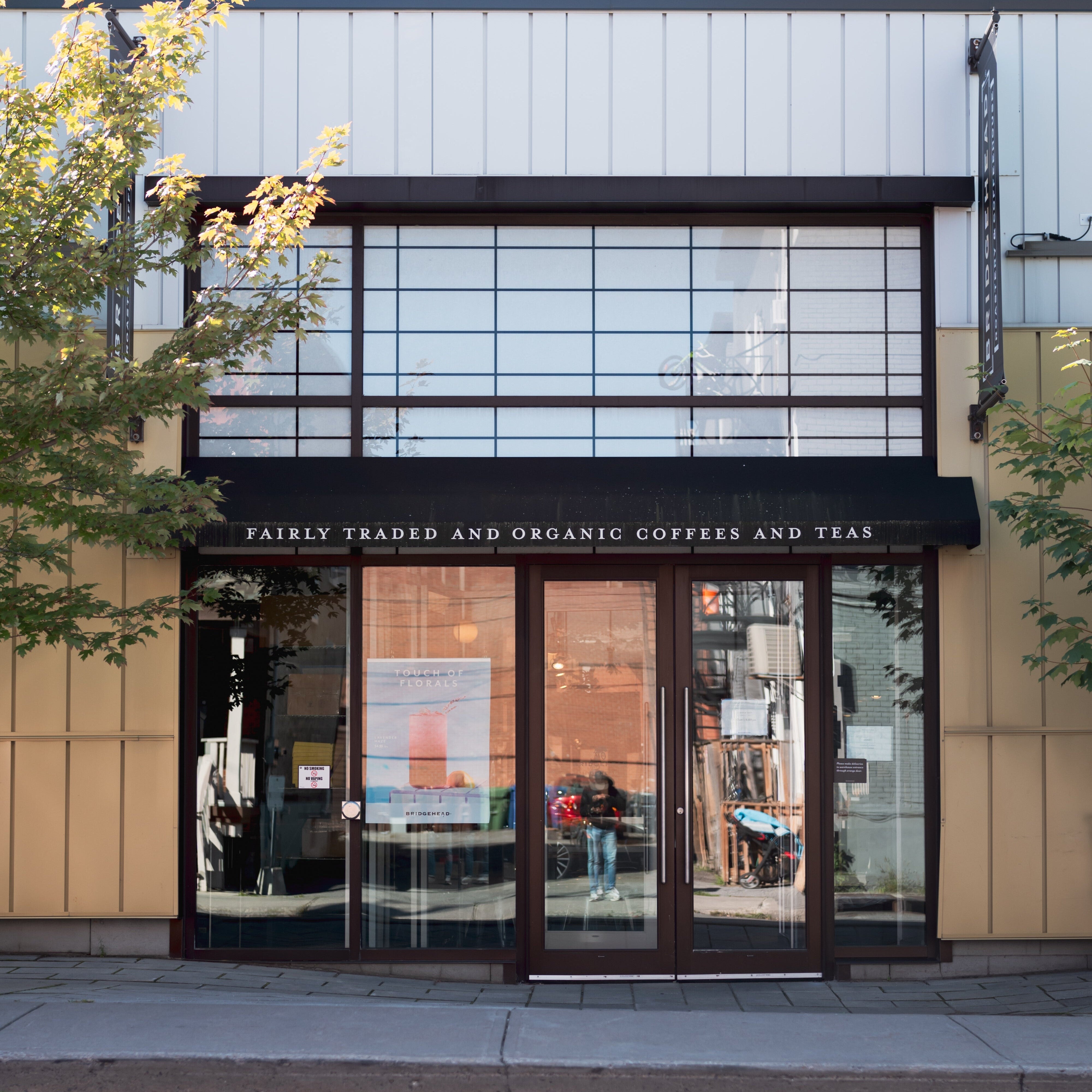 Storefront with glass doors and a sign indicating fairtrade and organic products.