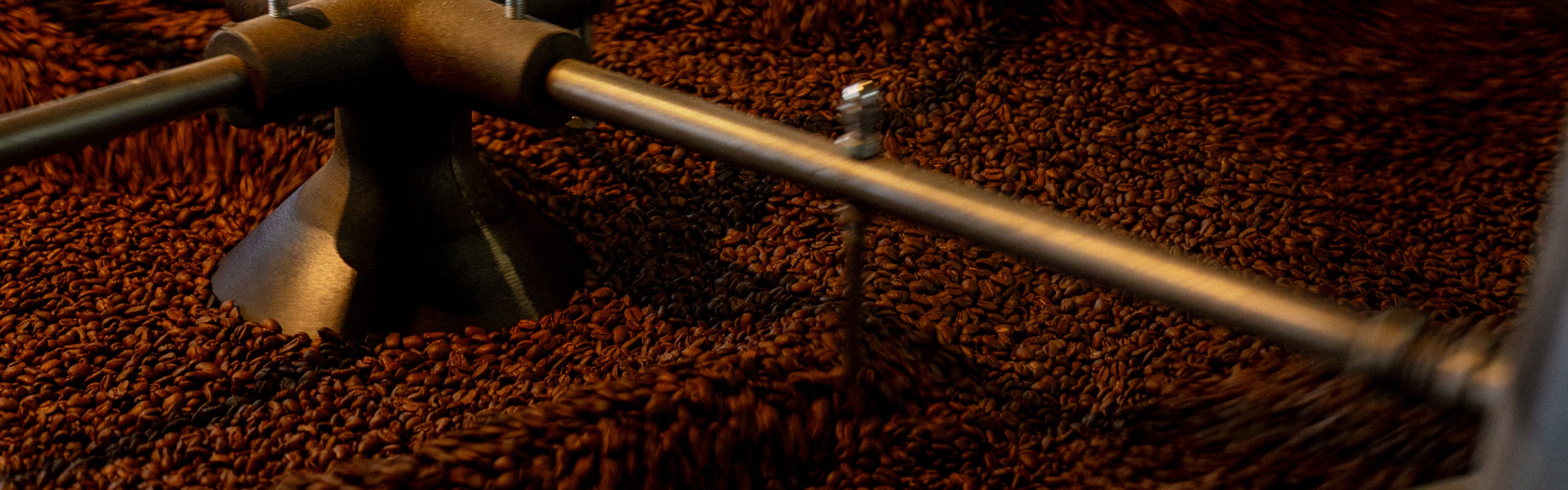 Close-up of a coffee roasting machine with coffee beans