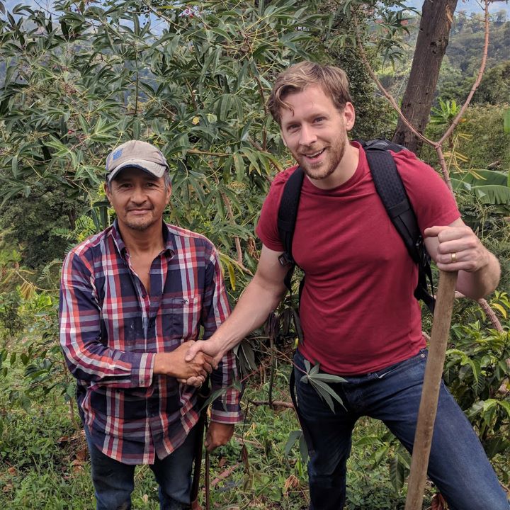 Ian Clark shaking hands with one of our farmers